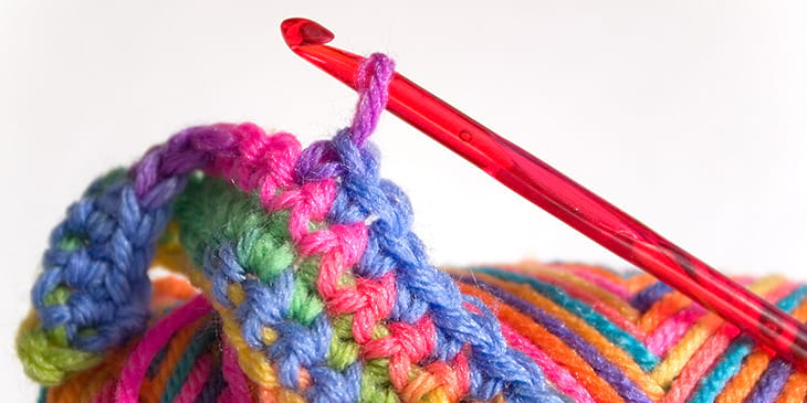 A crochet hook pulling on some yarn