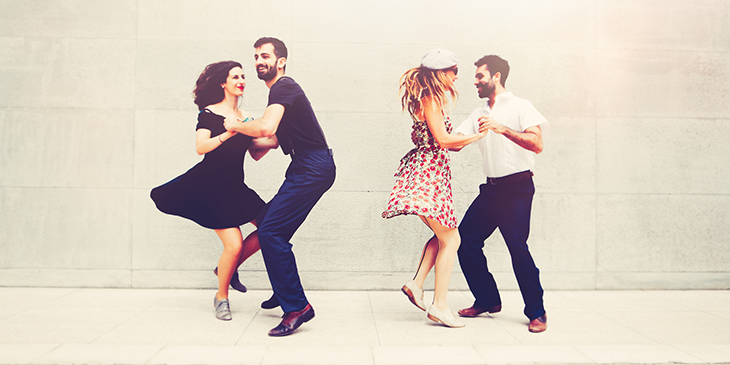 Two pairs of people dancing the Lindy hop