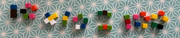 Cube blocks being used to spell out the sum 10 times 10 equals 100