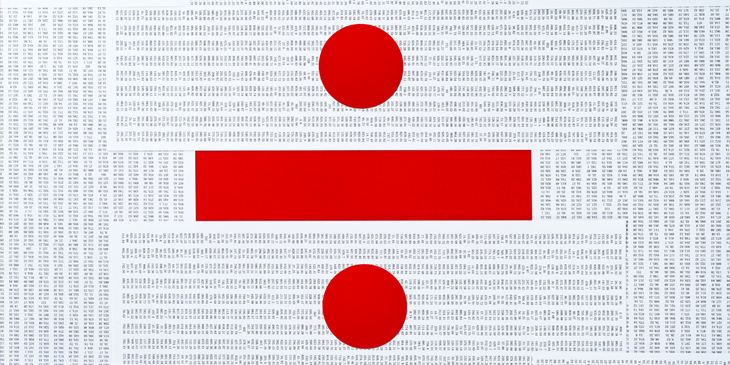 A large division symbol in red, over a white background featuring a range of mathematic numbers